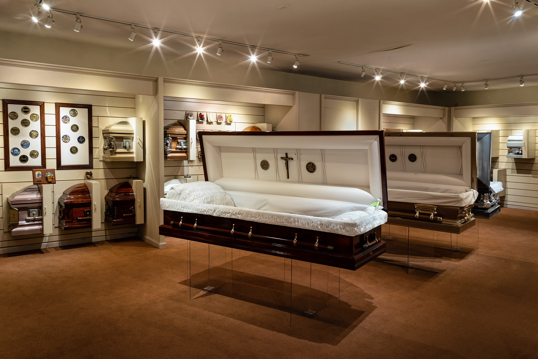 Our casket showroom displays choices in every price range, to stay comfortably within your budget. Many of our caskets can be customized with unique corner decorations, lid accessories, and religious or military symbols.